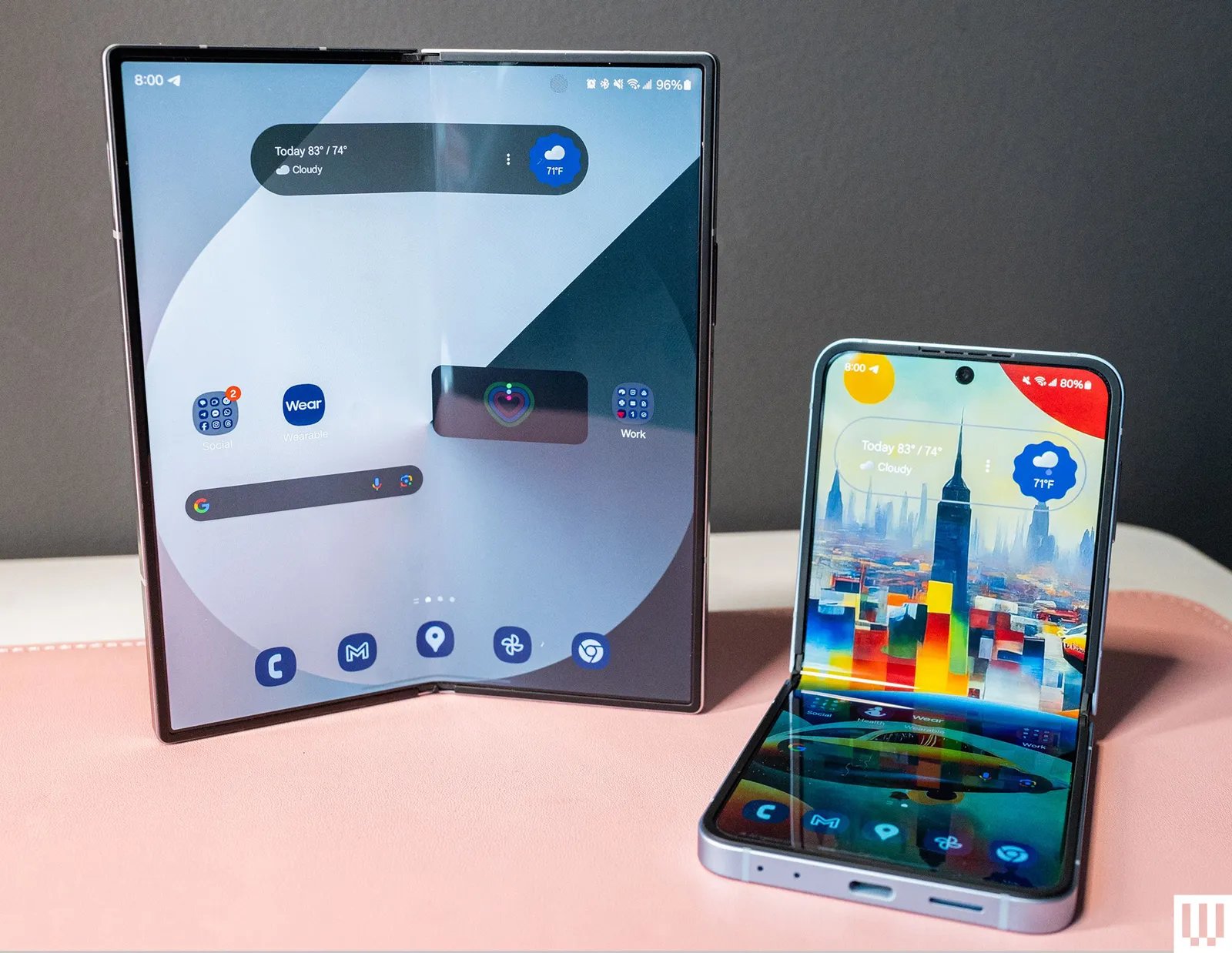 Two foldable mobile phones side by side with one in the vertical upright. position and the other in an Lshaped hinge...